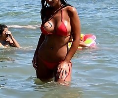 Enjoy hard nipples sticking under girls' wet bikinis