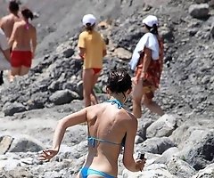 Beach hunter admires sexy bikinis